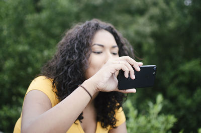 Young woman using mobile phone outdoors
