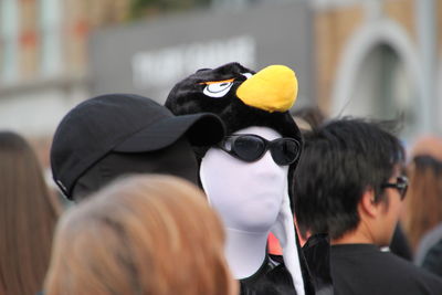 Man wearing mask amidst crowd in city