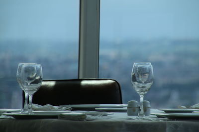 Close-up of wine glasses on table