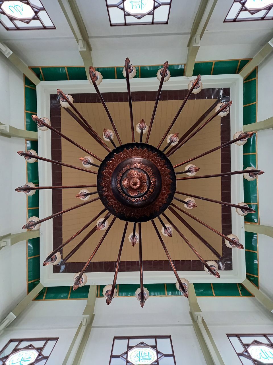 LOW ANGLE VIEW OF CHANDELIER HANGING FROM CEILING