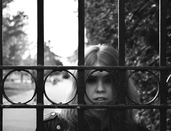 Close-up of woman standing by gate