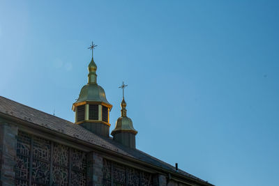 A detailed church tower on a clear blue sky