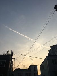 Low angle view of silhouette cables against sky