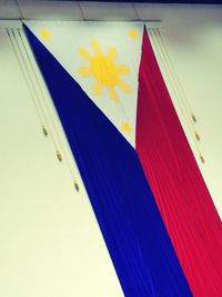 Close-up of multi colored pencils against blue sky