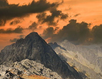 Landscape with dark rocky mountain ridge in sunset hour, high tatra mountains