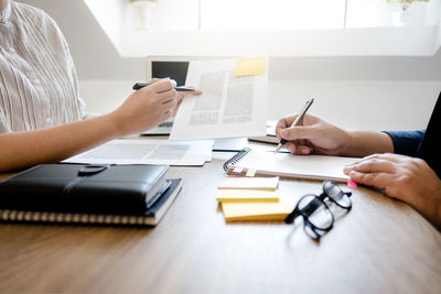 Midsection of woman working on table