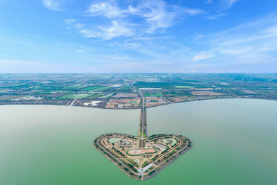 Aerial view of heart shaped island against sky