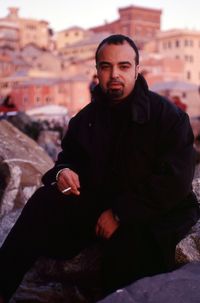 Portrait of young man sitting outdoors