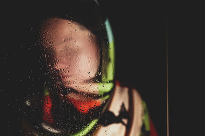 Close-up portrait of wet glass