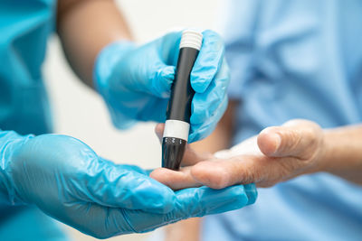 Midsection of doctor holding syringe