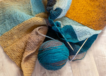 Photography with colored knitting, needles and a ball of wool yarn, knitting as a hobby, handmade