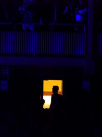 Silhouette man in illuminated room