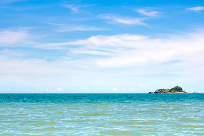 Wide view of sea and the mountain on island with blue sky background