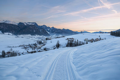 Winter mountain landscape at sunrise. walchsee village, austria.