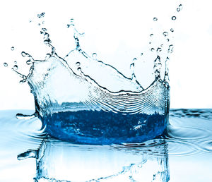 Close-up of water splashing against white background