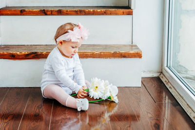 Cute baby boy on hardwood floor