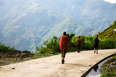 Rear view of two men hiking on mountain