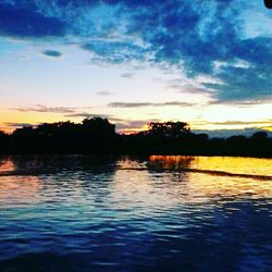 Scenic view of lake against sky at sunset