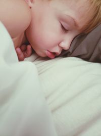 Cute baby boy sleeping on bed