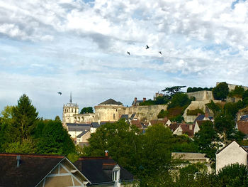 Buildings in town against sky