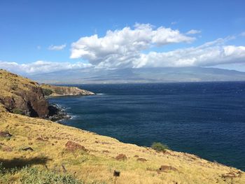 Scenic view of sea and mountains against sky