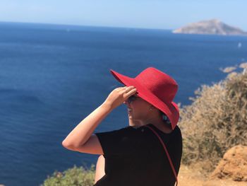 Woman wearing hat looking at sea