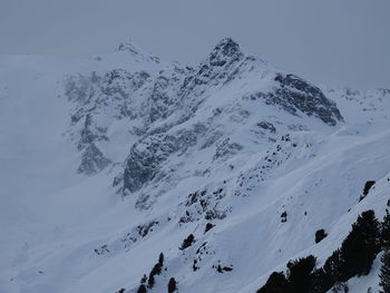 Aerial view of snow covered mountain against sky