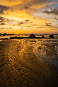 Scenic view of beach against sky during sunset