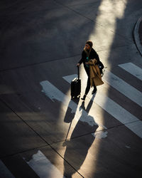 High angle view of woman walking on footpath