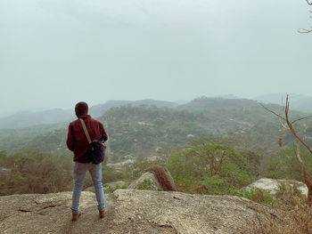 Rear view of man standing on mountain