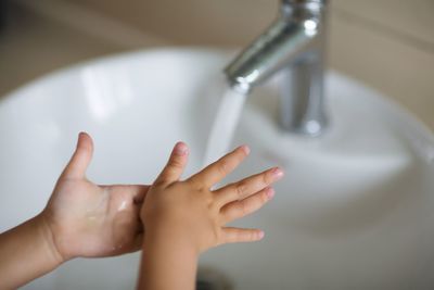 Midsection of woman in bathroom at home