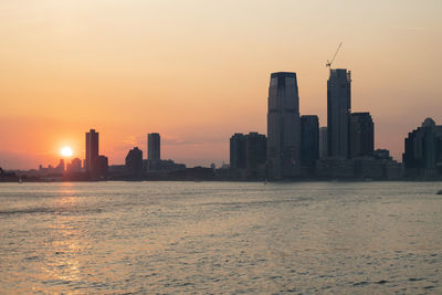 Buildings in city during sunset