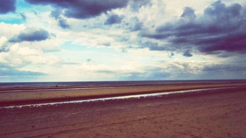 Scenic view of landscape against cloudy sky