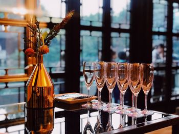 Glass of bottles on table at restaurant