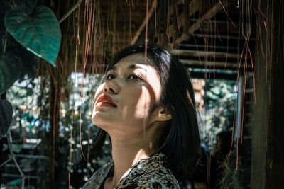 Young woman looking away outdoors