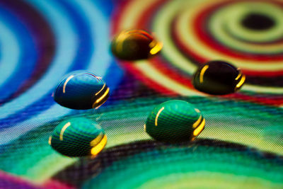 Close-up of water drops on colorful display screen