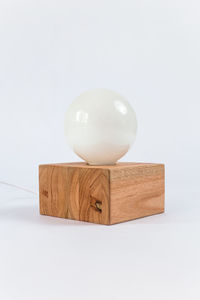 Close-up of ball on table against white background