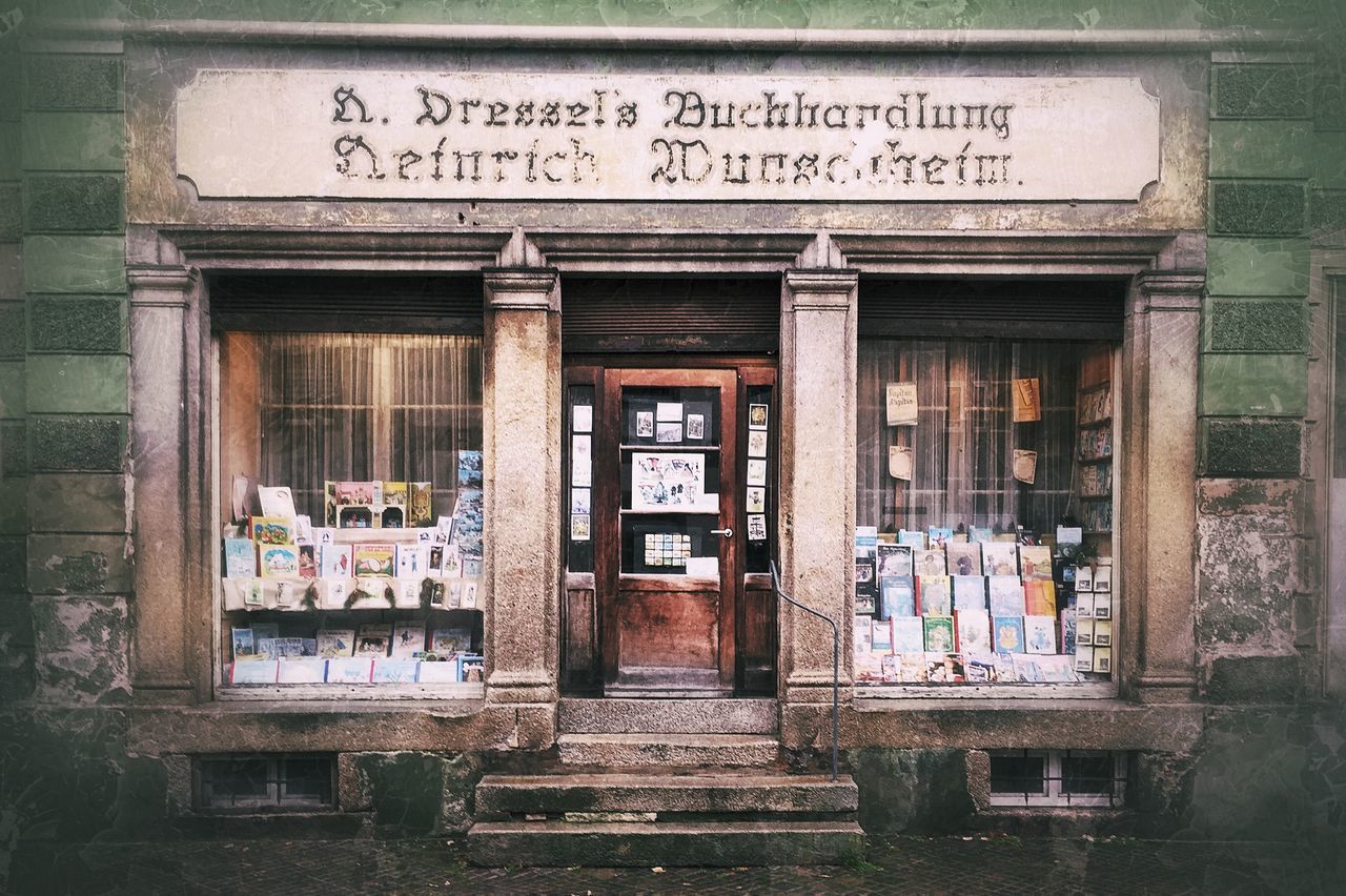 text, architecture, built structure, building exterior, western script, non-western script, communication, old, abandoned, damaged, obsolete, entrance, door, building, run-down, wood - material, weathered, outdoors, day, window