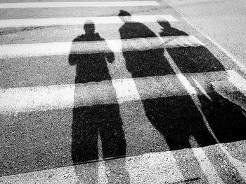 Shadow of people on road