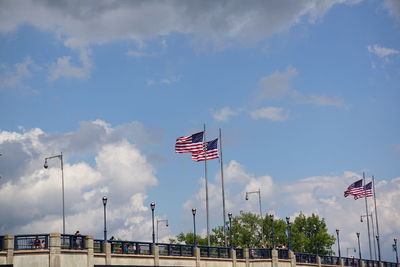 Low angle view of flags against sky