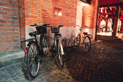 Bicycle parked against wall in city