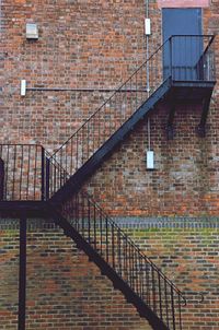 Staircase against brick wall