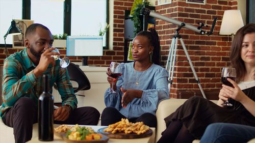 Friends using mobile phone while sitting at restaurant