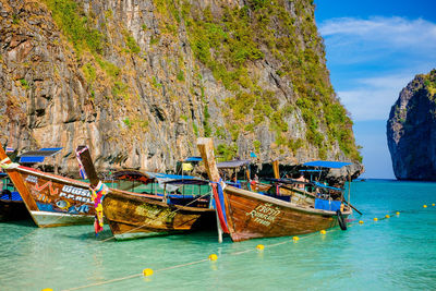 Boats moored in sea against sky