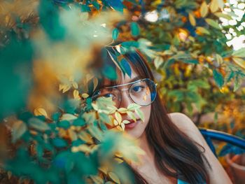 Portrait of young woman with autumn leaves