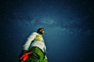 Low angle view of bird against sky at night