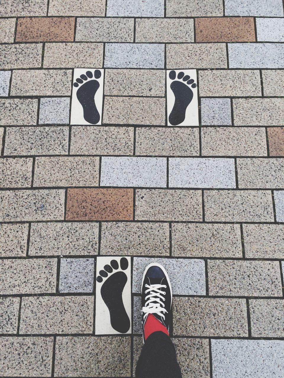 low section, shoe, standing, person, personal perspective, footwear, lifestyles, unrecognizable person, men, high angle view, street, day, leisure activity, text, communication, outdoors, pattern