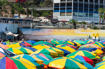 Multi colored swimming pool against buildings in city