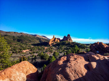 Scenic view of rocky mountains against clear blue sky