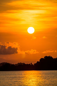 Scenic view of sea against orange sky